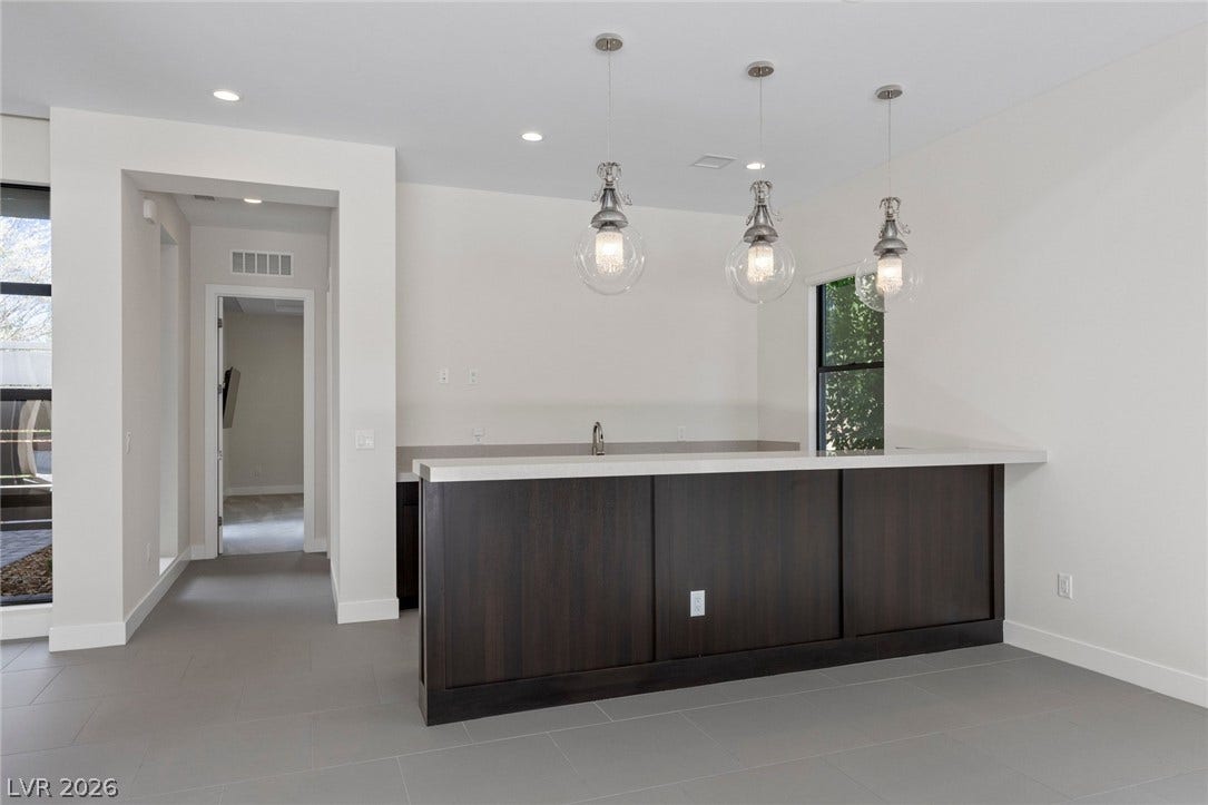 11453 Rhodolite Court, Las Vegas, NV 89135 Clean lines and smooth tile flooring define this modern entertainment space.