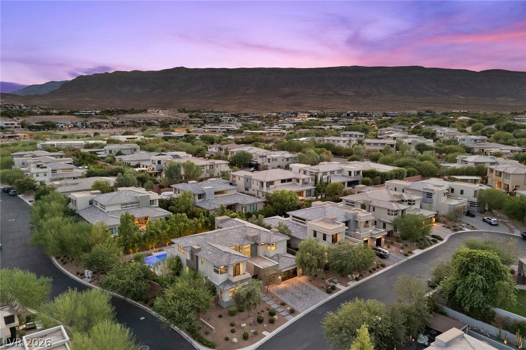11453 Rhodolite Court, Las Vegas, NV 89135 Dramatic mountain vistas rise above this exclusive master-planned neighborhood under a colorful twilight sky.