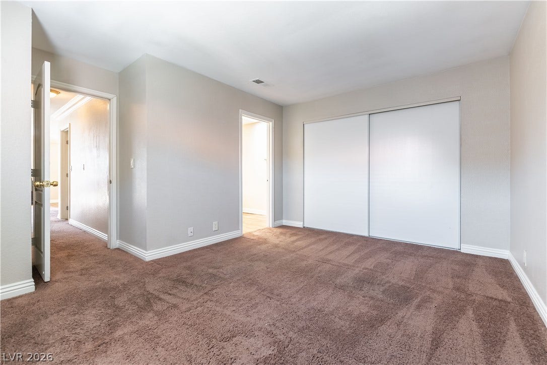 4050 Pacific Harbors Drive, #203, Las Vegas, NV 89121 Plush carpeting and a large sliding closet door define this versatile auxiliary bedroom.
