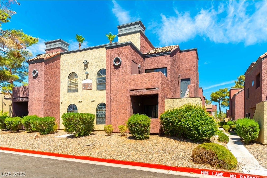 4050 Pacific Harbors Drive, #203, Las Vegas, NV 89121 Multi-level stucco exteriors feature arched windows, private entryways, and neat desert landscaping.