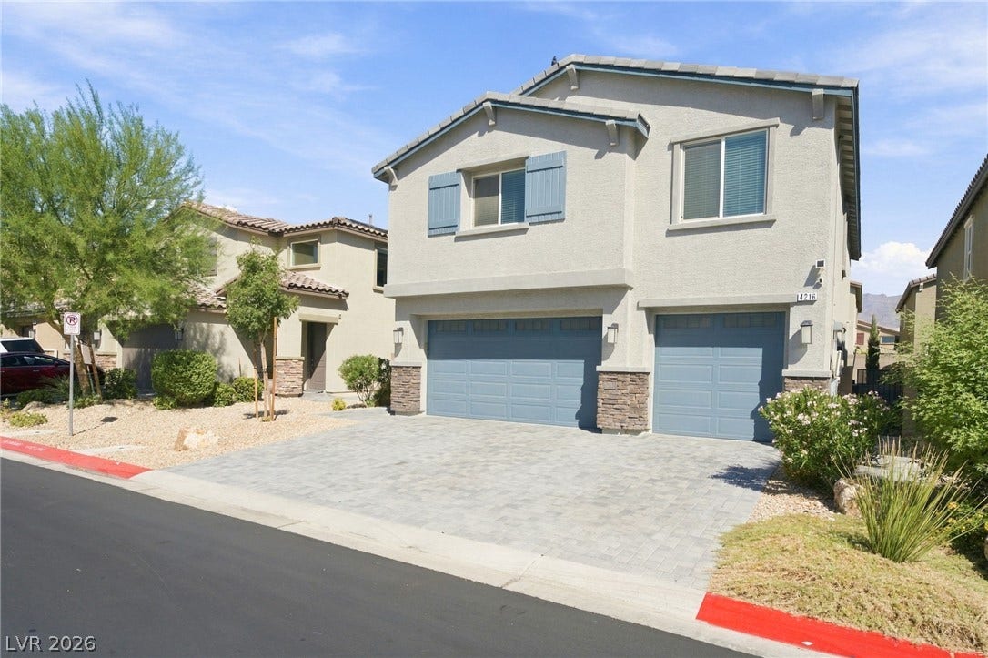 4216 Campriani Avenue, North Las Vegas, NV 89084 A paved driveway leads to the multi-car garage of this contemporary two-story home.