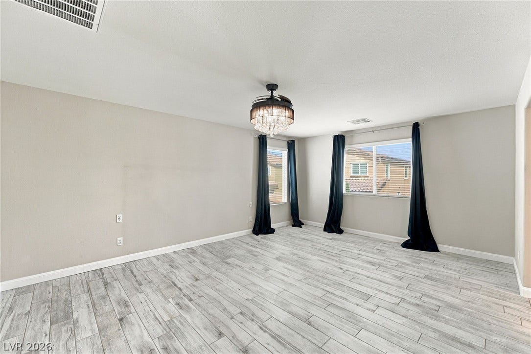 4216 Campriani Avenue, North Las Vegas, NV 89084 Plank flooring and dual windows highlight this versatile main living area.