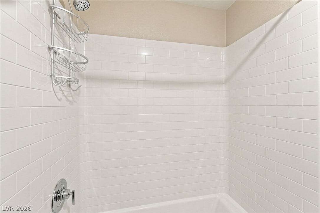 4216 Campriani Avenue, North Las Vegas, NV 89084 Crisp subway tile surrounds a classic shower and tub combination.