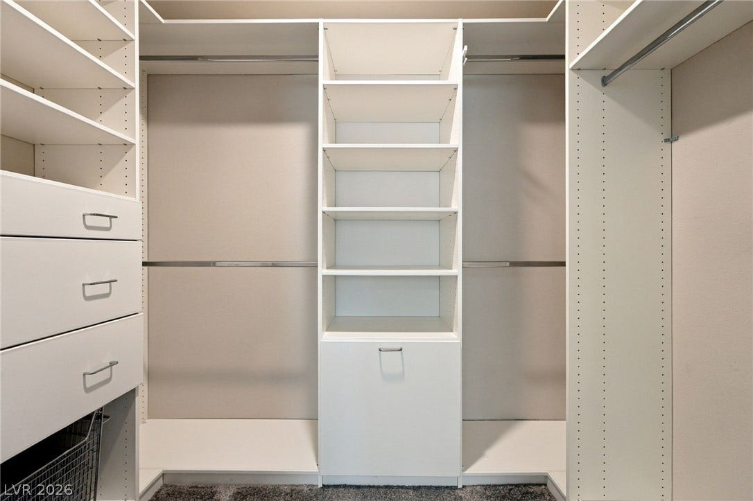 4216 Campriani Avenue, North Las Vegas, NV 89084 Custom built-in shelving and hanging rods maximize storage in this spacious walk-in closet.