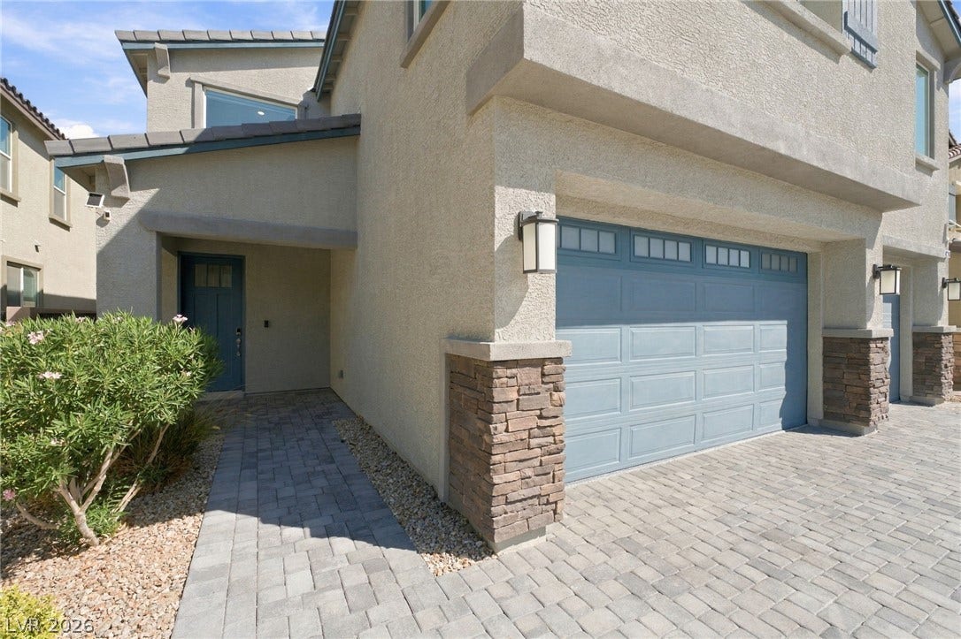 4216 Campriani Avenue, North Las Vegas, NV 89084 A paved walkway leads past a stone-accented garage to the inviting front entry.