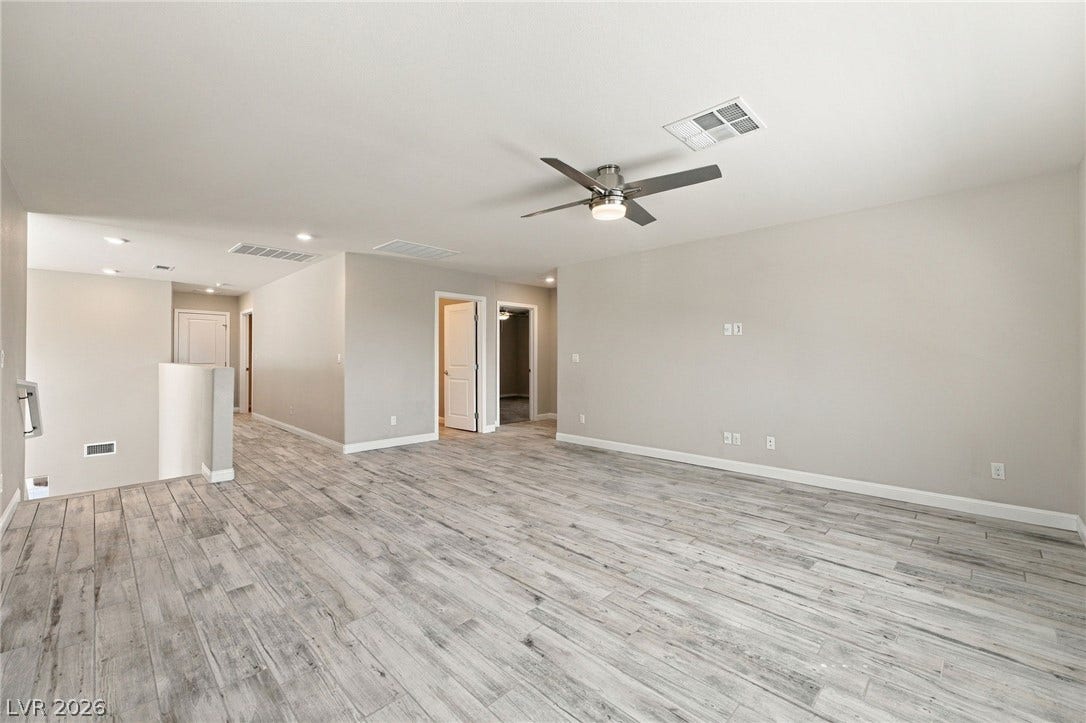 4216 Campriani Avenue, North Las Vegas, NV 89084 Gleaming wood-look tile floors stretch across a versatile upstairs living space.