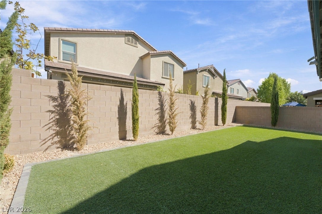 4216 Campriani Avenue, North Las Vegas, NV 89084 A manicured lawn and high privacy walls define this tidy backyard space.