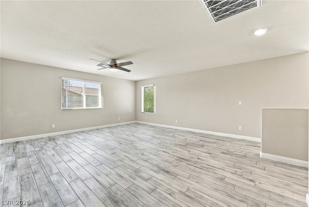 4216 Campriani Avenue, North Las Vegas, NV 89084 Gleaming wood-look tile floors and dual windows define this versatile upper-level living space.