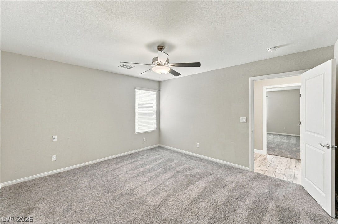 4216 Campriani Avenue, North Las Vegas, NV 89084 Plush wall-to-wall carpeting and clean neutral walls define this comfortable bedroom space.