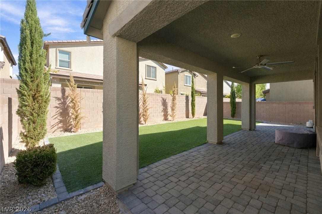 4216 Campriani Avenue, North Las Vegas, NV 89084 An inviting covered patio paved in brick pavers overlooks a manicured green lawn.