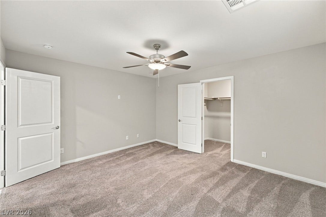4216 Campriani Avenue, North Las Vegas, NV 89084 Plush carpeting and a walk-in closet highlight this comfortable bedroom space.