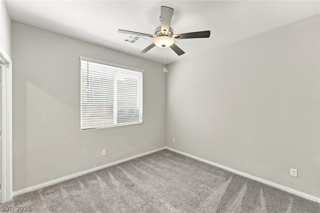 4216 Campriani Avenue, North Las Vegas, NV 89084 Plush carpeting anchors this versatile room under a smooth ceiling with trim molding.