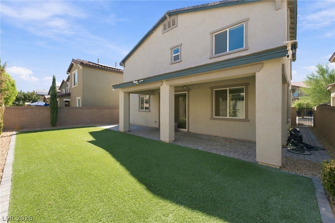 4216 Campriani Avenue, North Las Vegas, NV 89084 A covered patio overlooks a low-maintenance lawn bordered by high privacy fencing.
