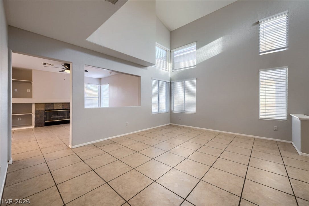 6027 Dawn View Lane, North Las Vegas, NV 89031 Soaring ceilings and neutral tile flooring define this light-filled main living space.