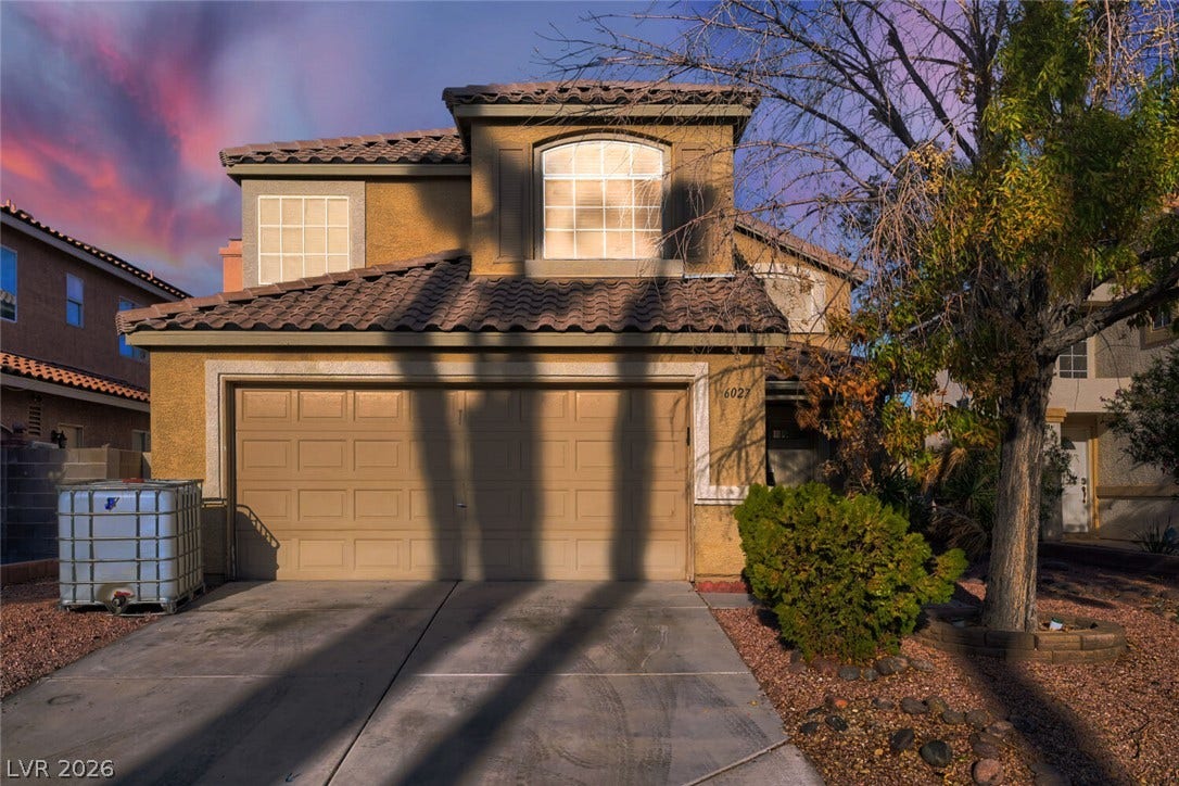 6027 Dawn View Lane, North Las Vegas, NV 89031 A classic stucco exterior is complemented by a tiled roof and a two-car garage.