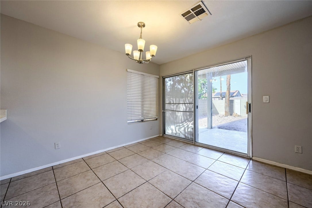 6027 Dawn View Lane, North Las Vegas, NV 89031 Tile flooring and sliding glass doors open directly to the covered back patio.