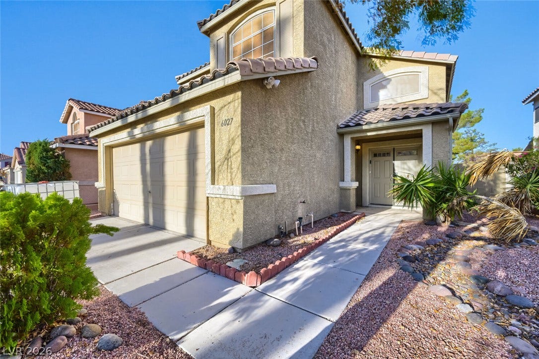 6027 Dawn View Lane, North Las Vegas, NV 89031 Spanish tile roof accents and a manicured stone pathway frame the welcoming front entry.