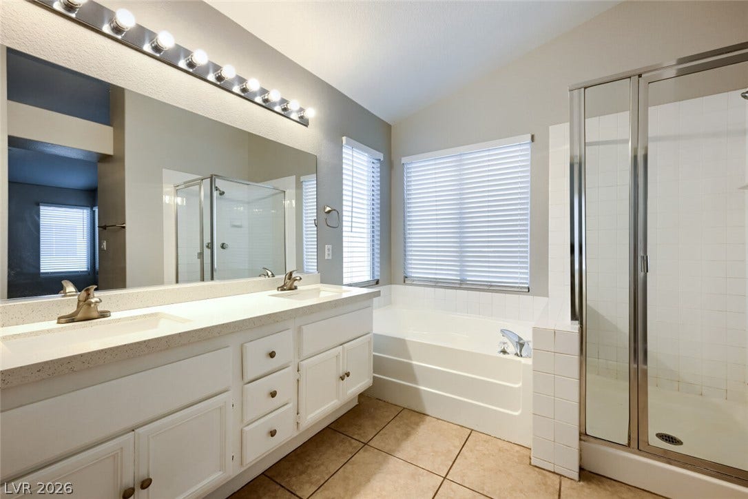 6027 Dawn View Lane, North Las Vegas, NV 89031 A spacious vanity and separate soaking tub define this well-appointed layout.