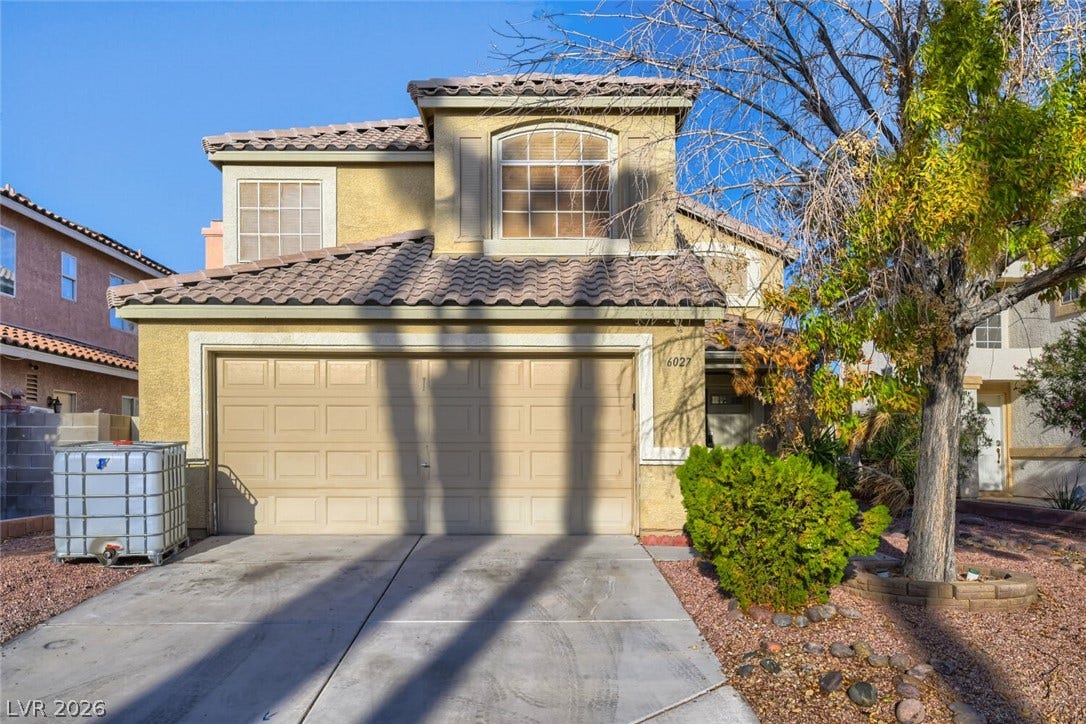 6027 Dawn View Lane, North Las Vegas, NV 89031 A classic Spanish tile roof accents this two-story exterior featuring an attached two-car garage.