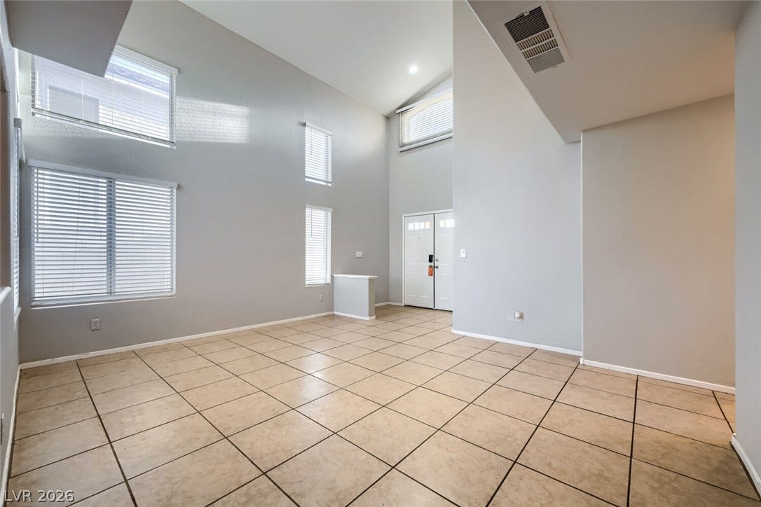 6027 Dawn View Lane, North Las Vegas, NV 89031 Soaring vaulted ceilings and expansive windows define this light-filled entry space with durable tile flooring.