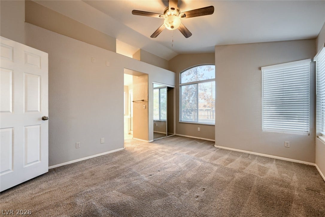 6027 Dawn View Lane, North Las Vegas, NV 89031 High vaulted ceilings and ample window installations create a sense of openness in this bedroom.