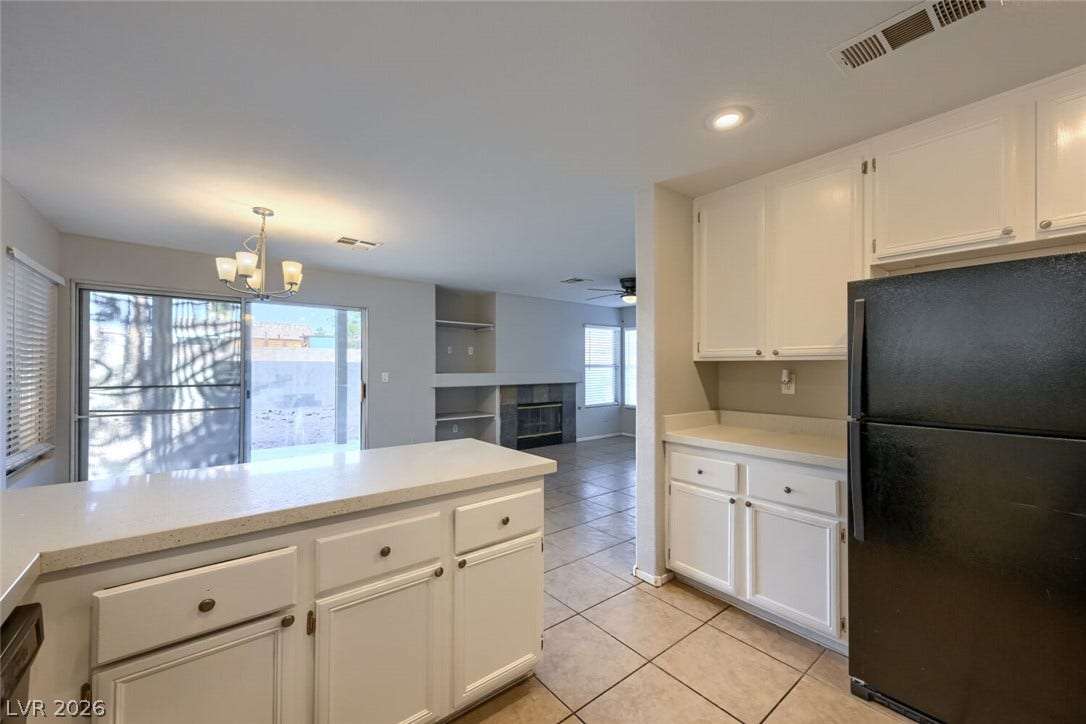 6027 Dawn View Lane, North Las Vegas, NV 89031 Tile flooring runs from the functional kitchen into an adjacent open living space.