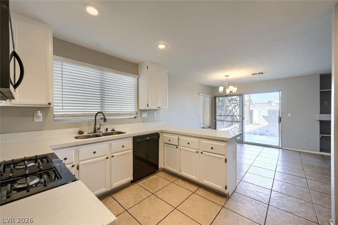 6027 Dawn View Lane, North Las Vegas, NV 89031 An open layout connects the kitchen to the bright dining area with tile flooring.