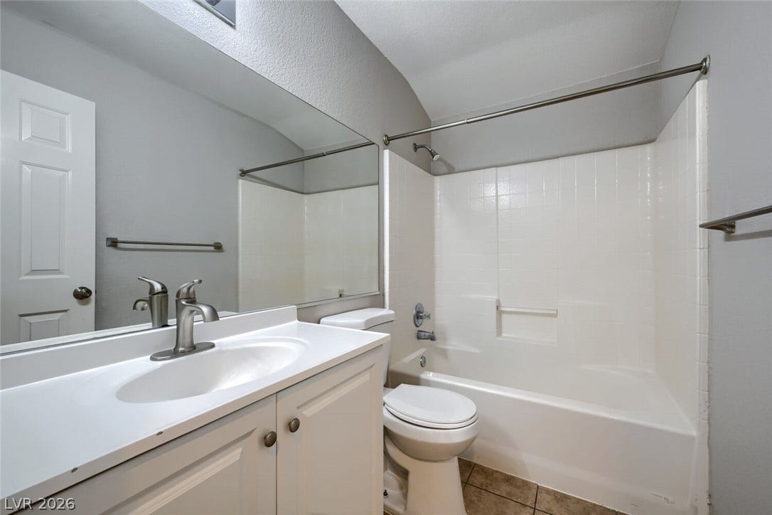6027 Dawn View Lane, North Las Vegas, NV 89031 Tiled flooring and a classic tub shower assembly complete this updated bathroom space.