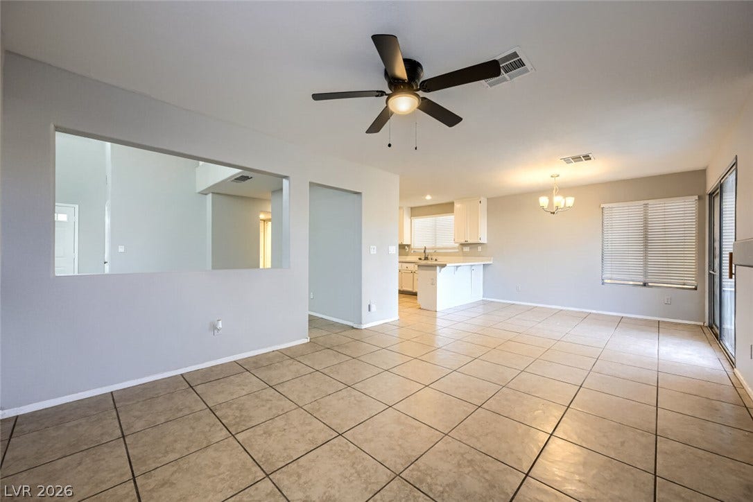 6027 Dawn View Lane, North Las Vegas, NV 89031 Tiled flooring and an open layout connect the central living areas.