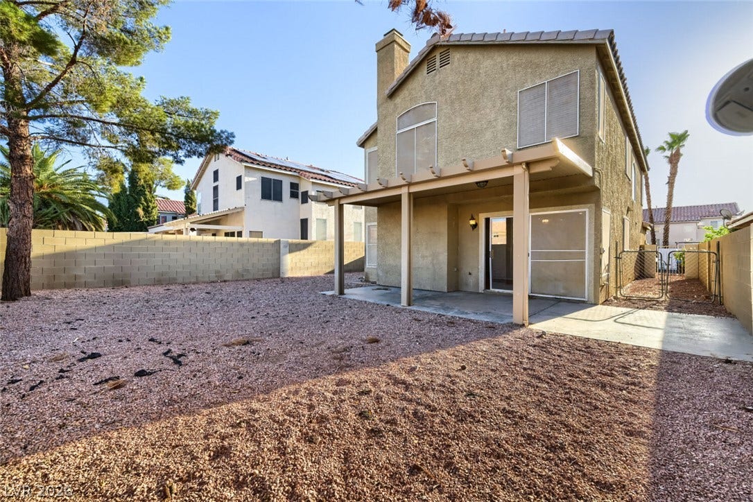 6027 Dawn View Lane, North Las Vegas, NV 89031 A spacious gravel yard features a covered concrete patio and protective privacy block walls.
