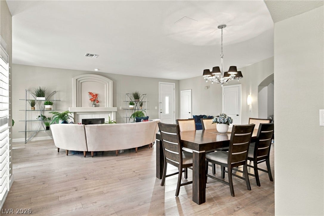 An open floorplan seamlessly connects the dining space to a comfortable living area.