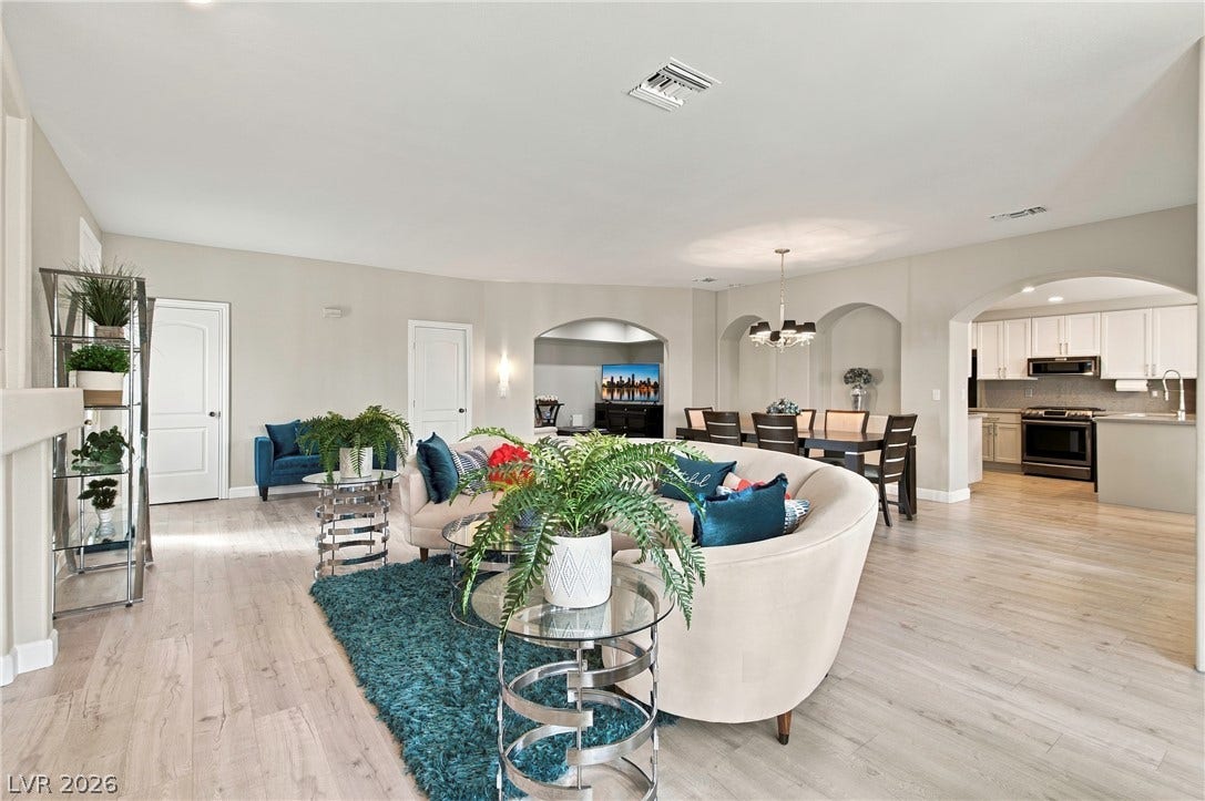 Arched doorways and wood flooring flow seamlessly throughout this open-concept main level.