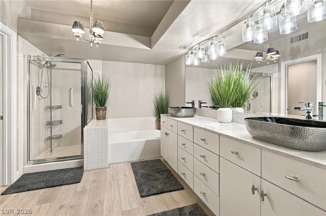 Indulge in a spa-like retreat boasting a glass shower enclosure and a generous soaking tub.