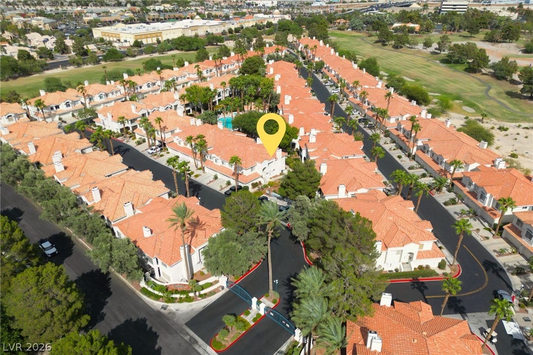 Aerial view highlights this premier neighborhood situated alongside a lush local golf course.