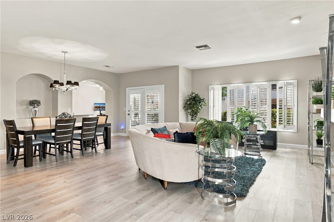 Smooth wood floors flow seamlessly through this open-concept living and dining space.