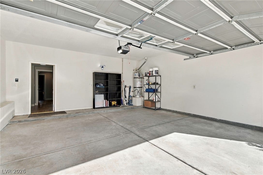 Clean concrete flooring and high ceilings define this functional, spacious garage space.