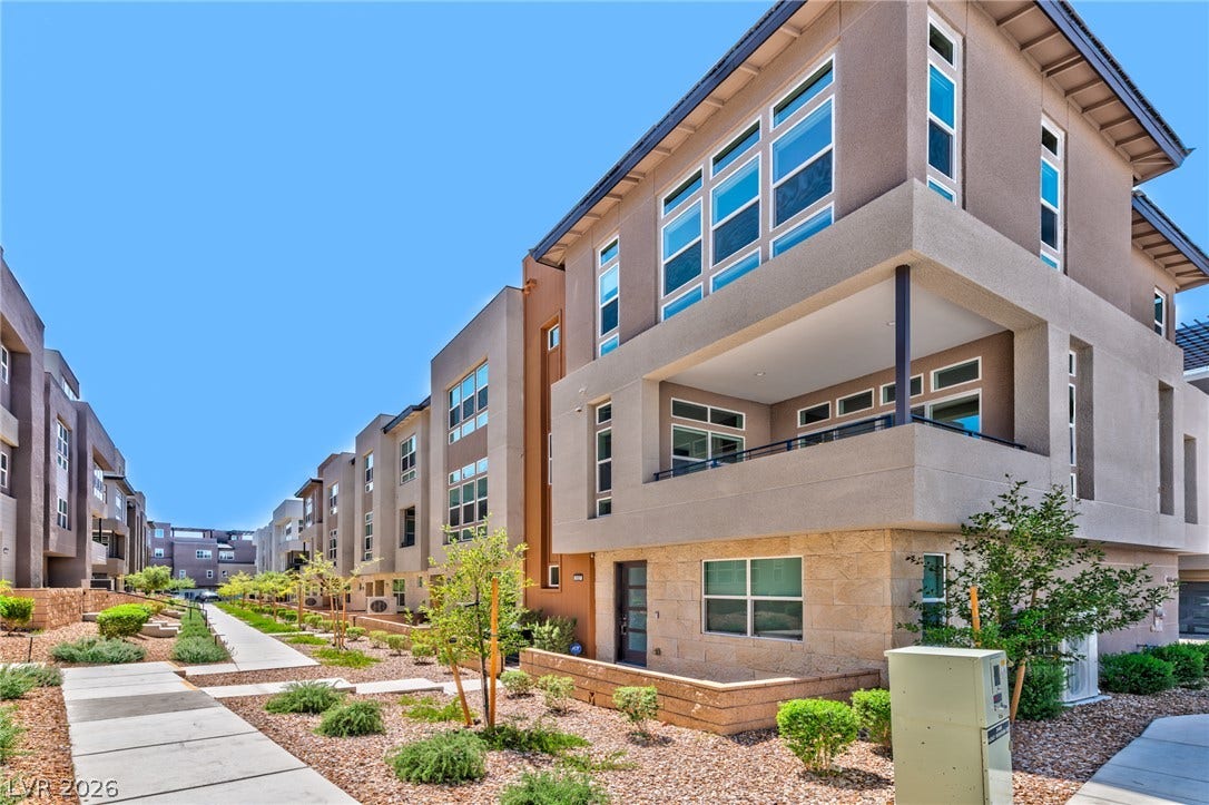 3327 Esker Ridge Avenue, Henderson, NV 89044 Modern multi-level exterior showcases clean architectural lines, stone accents, and private outdoor balconies.
