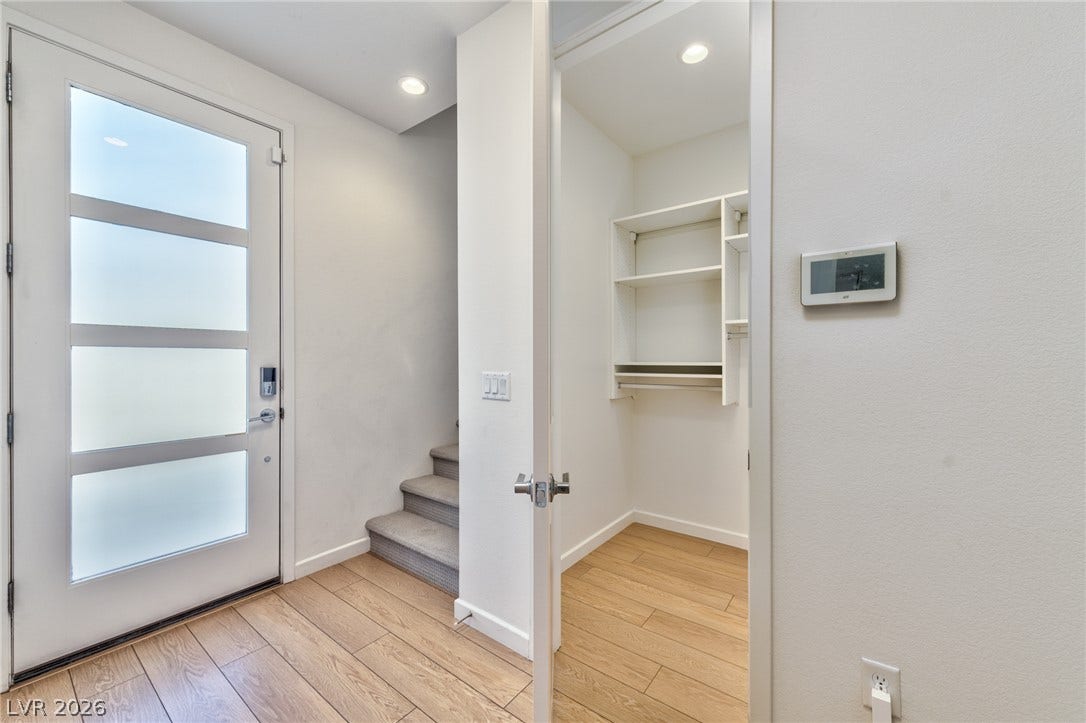 3327 Esker Ridge Avenue, Henderson, NV 89044 Gleaming hardwood floors and a modern glass-paneled door welcome guests into this light-filled entry.
