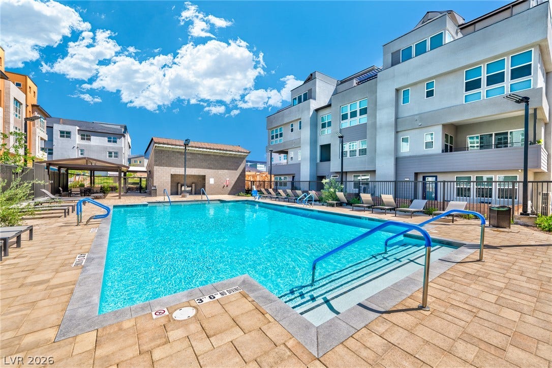 3327 Esker Ridge Avenue, Henderson, NV 89044 A sparkling community pool sits surrounded by neat paver decking and contemporary residential architecture.