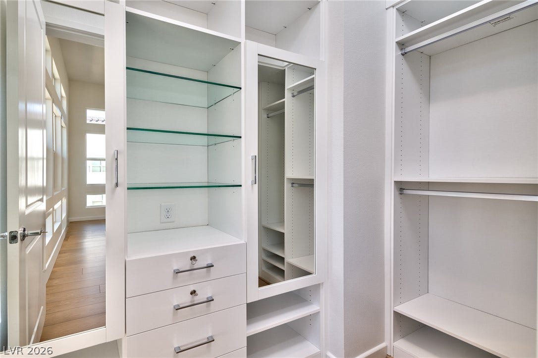 3327 Esker Ridge Avenue, Henderson, NV 89044 Custom built-in shelving and ample hanging space define this organized walk-in closet.