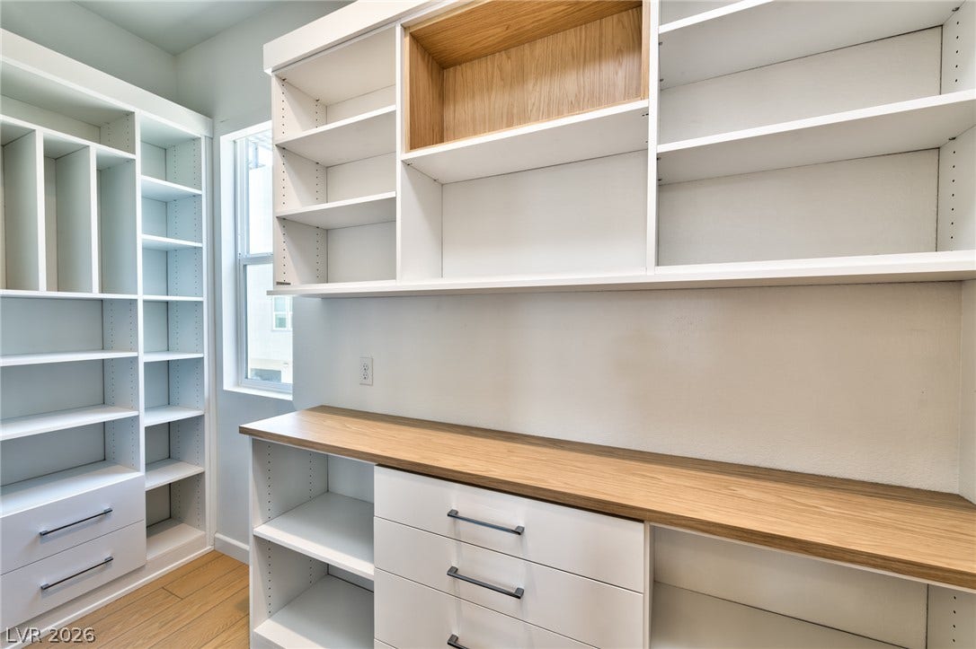 3327 Esker Ridge Avenue, Henderson, NV 89044 Custom built-in shelving and ample counter space maximize organization in this modern closet.