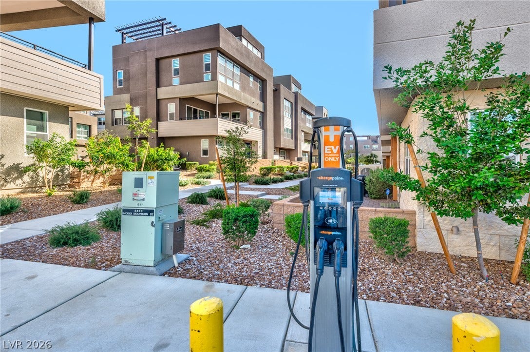 3327 Esker Ridge Avenue, Henderson, NV 89044 Modern multi-level townhomes sit surrounded by manicured pathways and on-site electric vehicle charging stations.