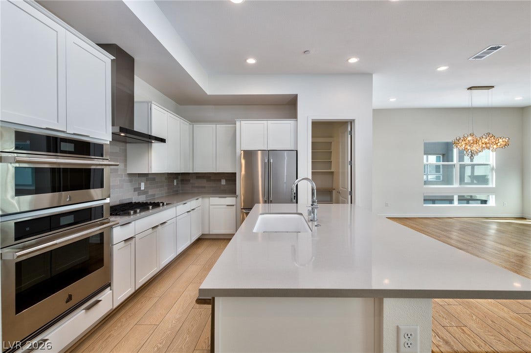 3327 Esker Ridge Avenue, Henderson, NV 89044 An expansive breakfast bar island overlooks the open floorplan dining space.