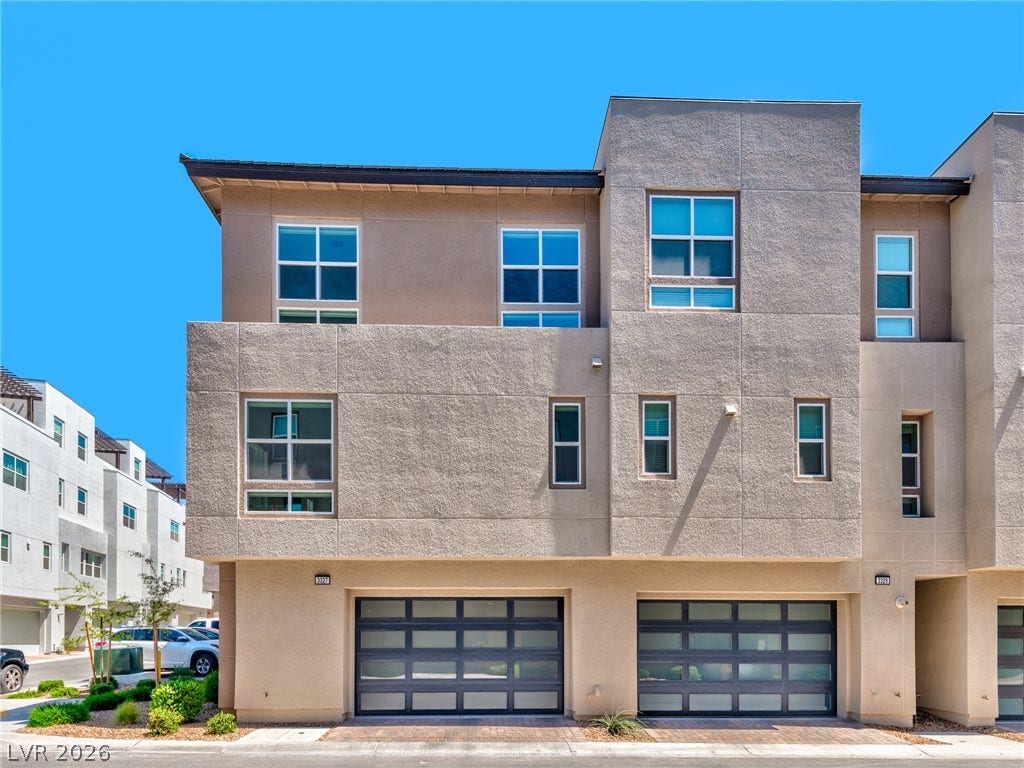 3327 Esker Ridge Avenue, Henderson, NV 89044 Modern multi-level exterior showcases clean architectural lines and integrated garage doors.