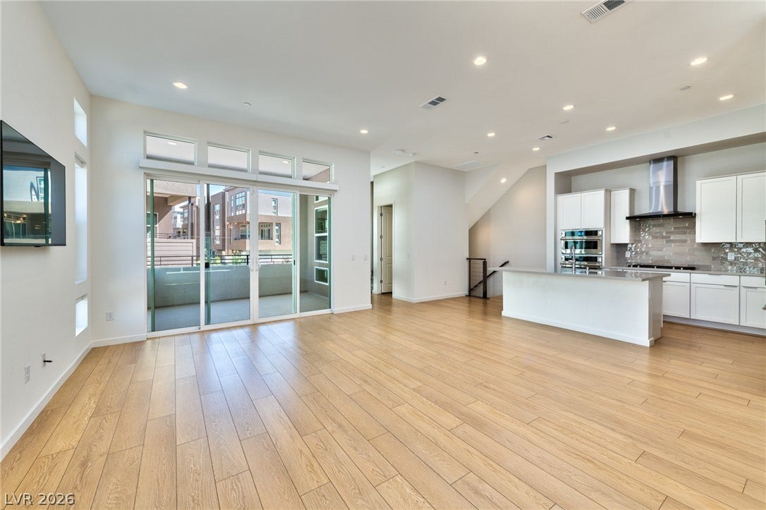 3327 Esker Ridge Avenue, Henderson, NV 89044 Clean lines and warm hardwood flooring define this open-concept main living area.