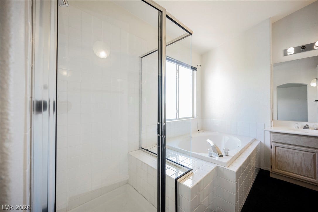 1608 Saddle Rock Circle, Las Vegas, NV 89117 Natural light fills this bathroom featuring a separate soaking tub and glass-enclosed shower.