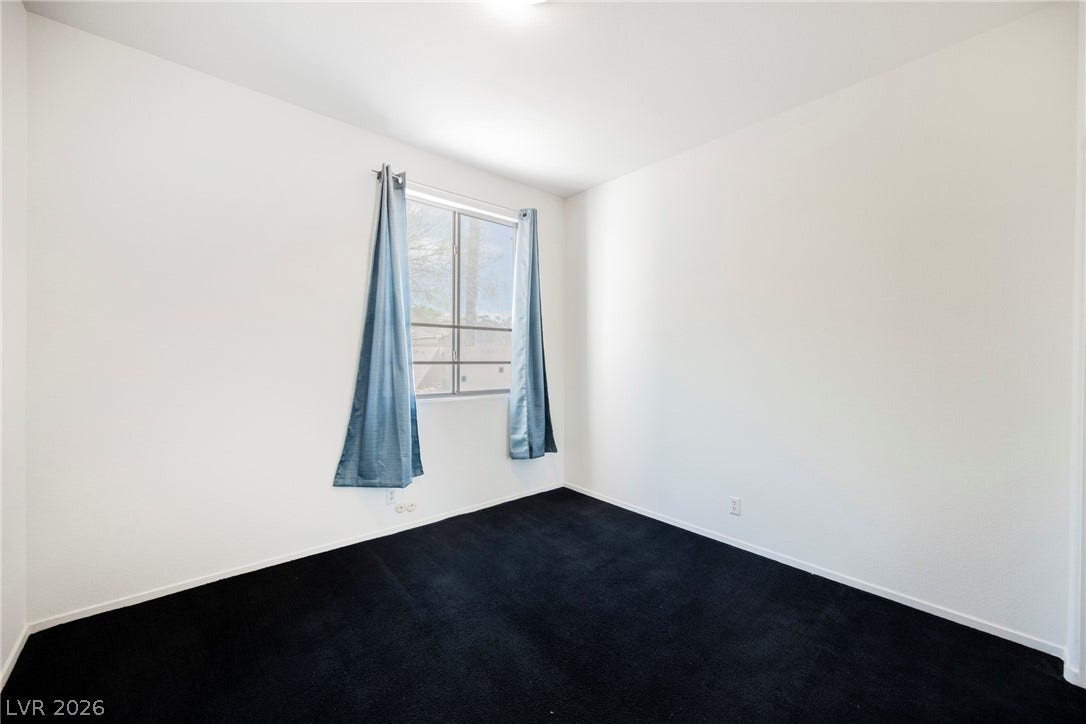 1608 Saddle Rock Circle, Las Vegas, NV 89117 Deeply saturated dark carpeting grounds this versatile bedroom space filled with natural light.