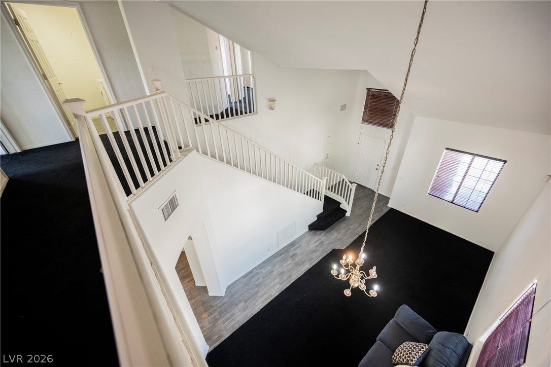 1608 Saddle Rock Circle, Las Vegas, NV 89117 An open multi-level floorplan is highlighted by soaring vaulted ceilings and an elegant chandelier.
