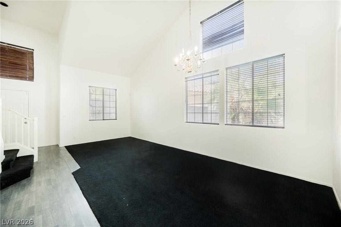 1608 Saddle Rock Circle, Las Vegas, NV 89117 Soaring vaulted ceilings and tall windows anchor this airy, light-filled living space.