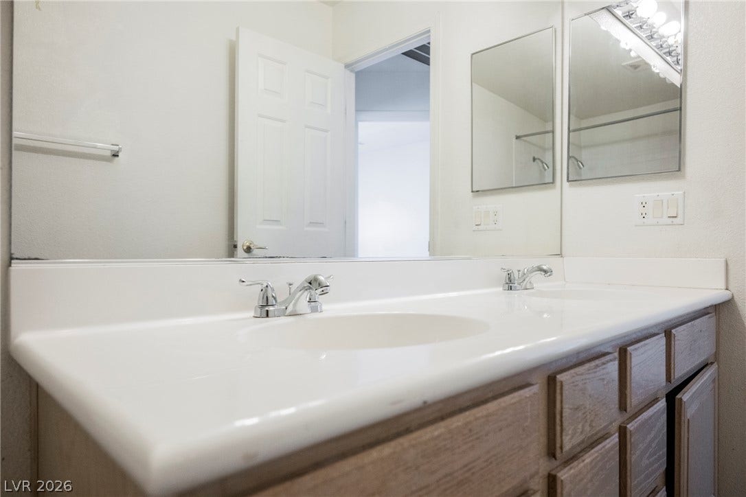 1608 Saddle Rock Circle, Las Vegas, NV 89117 A spacious double vanity features clean countertops and ample cabinet storage.